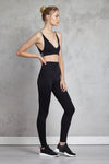 Full body length side view of a woman wearing Cindy Bralette - Black and black leggings