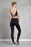 Full body length back view of a woman wearing Cindy Bralette - Black and black leggings