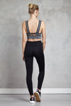 Full body length back view of a woman wearing Kate Legging - Black and a dark heather crop top