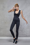 Full body length front view of a woman wearing Phoebe Bodysuit - Black in a pose
