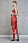 Full body length side view of a woman wearing Caroline Legging - Chilli / Nude with a matching sports bra