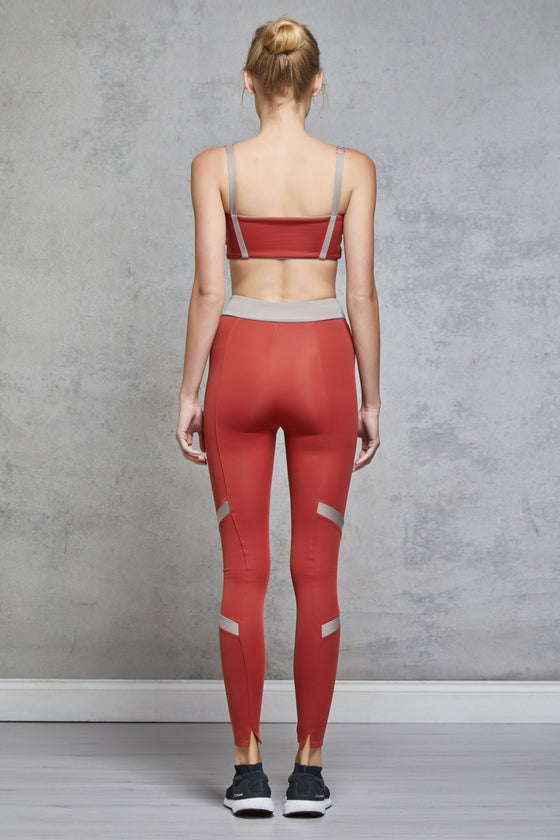 Full body length back view of a woman wearing Caroline Legging - Chilli / Nude with a matching sports bra