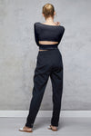 Full body length back view of a woman wearing Bojana Ballet Top - Black and black sweatpants