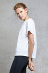 Side view of a woman wearing Silou Tee - White