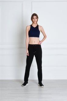  Full body length front view of a woman wearing Uma Sweatpant - Black