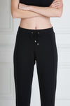 Front view of a woman wearing Uma Sweatpant - Black