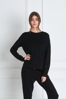  Front view of a woman wearing Uma Sweatshirt - Black and black sweatpants
